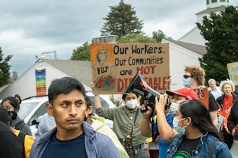 caption: Farmworker activist and union leader Alfredo Juarez Zeferino, known in his community as “Lelo,” (front left) during a protest for farmworker rights in 2023 in Olympia. Juarez was taken into custody Tuesday by ICE. He is being held at the Northwest Detention Center in Tacoma.