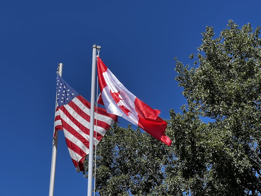 caption: On July 4, Point Roberts puts up a Canadian flag at the local community center. The streets fill with Canadians, who may have also been in town for Canada Day that same week.