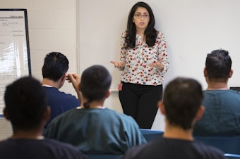 caption: Virginia Cole gives a legal workshop at the Northwest Detention Center in Tacoma. The U.S. Department of Justice has moved to halt some free legal help provided to immigrants.