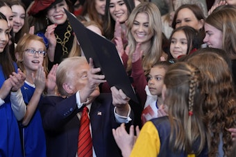 caption: President Donald Trump holds up a signed executive order barring transgender female athletes from competing in women's or girls' sporting events, in the East Room of the White House, Wednesday, Feb. 5, 2025, in Washington. 