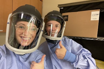 caption: Victoria Price (left) poses for a photo with a co-worker.