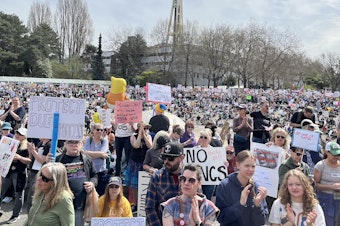 caption: Tens of thousands of people gathered at Seattle Center for an anti-Trump protest on Saturday, April 5, 2025.
