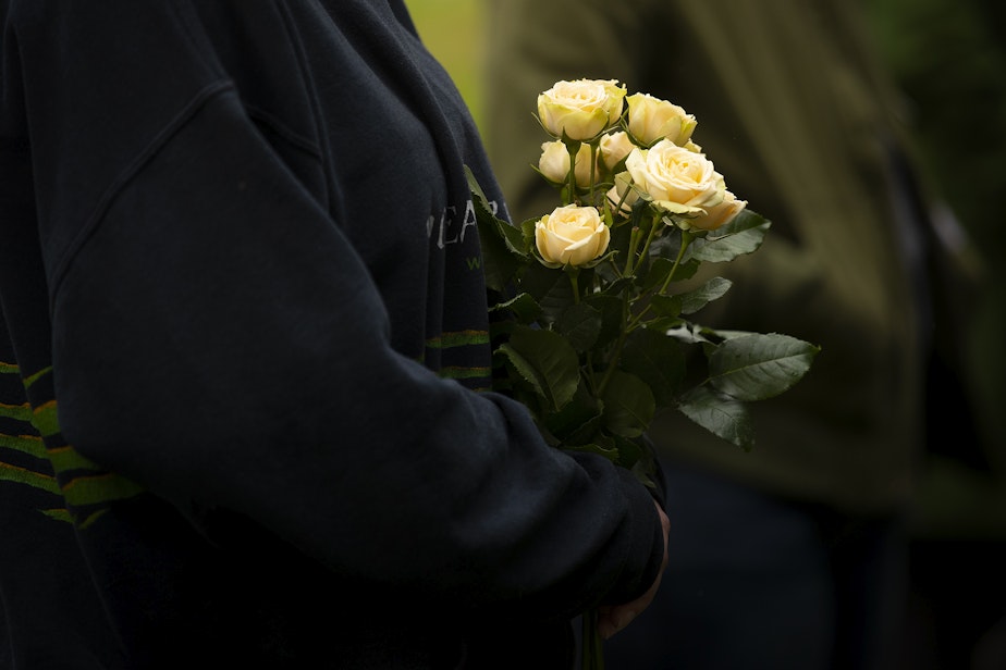 caption: People pay their respects during the 2023 Indigent Remains ceremony hosted by the King County Medical Examiner’s Office on Wednesday, Oct. 25, 2023, at Mt. Olivet Cemetery in Renton.
