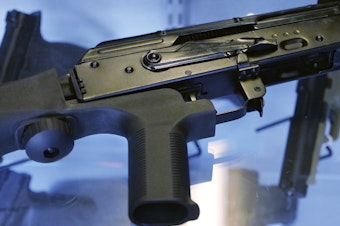 caption: A bump stock is attached to a semi-automatic rifle. The U.S. Supreme Court, Friday, June 14, 2024, struck down a ban on the rapid-fire rifle bump stock used by the gunman who rattled off over 1,000 bullets in 11 minutes in Las Vegas in 2017.