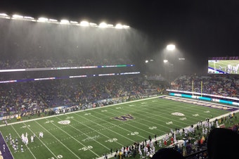 caption: Husky Stadium on a rainy game night in Seattle.