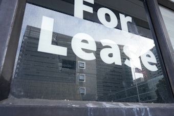 caption: The Speaker Nancy Pelosi Federal Building is reflected in a window of a vacant storefront Tuesday, March 4, 2025, in San Francisco. 