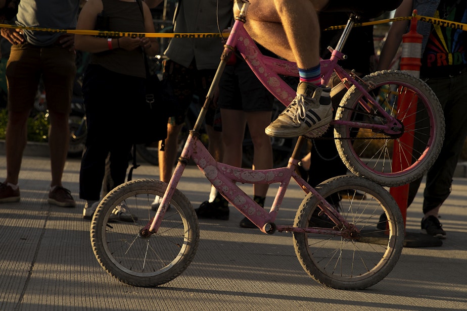 caption: People attempt to ride custom made bicycles in the ‘freak bike petting zoo,’ on Saturday, August 3, 2024, during the 28th annual Dead Baby Downhill, at the Hazard Factory in South Park.