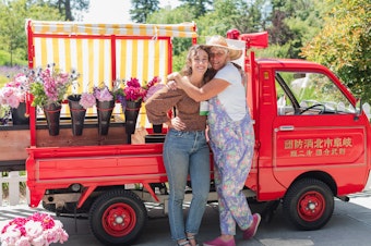 caption: Tonneli Gruetter, left, and Kim Gruetter of Salty Acres Whidbey Island Flower Farm had vase holders welded onto their firetruck, "Salty."