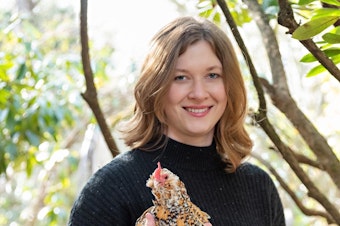 caption: Tove Danovich, journalist and author of "Under the Henfluence: Inside the World of Backyard Chickens and the People Who Love Them" poses for a photo with one of her pet chickens.