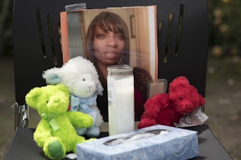 caption: A photo of Charleena Lyles stands in memorial.