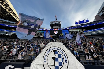 caption: The Royal Guard is the official fan group of the OL Reign, staking out sections 122 and 123 at Lumen Field.