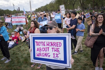caption: People attend a rally in support of transgender people during the Trans Day of Visibility, on the National Mall, Monday, March 31, 2025, in Washington.