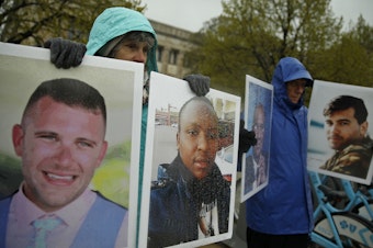 caption: Protesters hold photographs of victims, including Melvin Riffel, left, of the 2019 Ethiopian Airlines plane crash, outside Boeing's annual shareholders meeting in Chicago on April 29, 2019. Ike Riffel, a California father whose two sons, Melvin and Bennett, died in the crash, fears that instead of putting Boeing on trial, the government will offer the company another shot at corporate probation through a legal document called a deferred prosecution agreement, or DPA. 