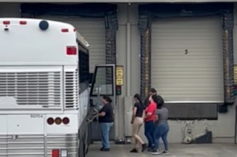 caption: Immigration agents arrest workers at a beverage factory in Kent on May 20, 2025.