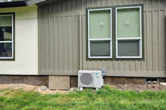 caption: A heat pump warms farmer Martin Vandepas' home in Greenbank, Washington, on May 20, 2025.