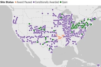 caption: Washington state is a blank spot on a map by EV States Clearinghouse that shows, in green, where states have opened vehicle charging stations using federal NEVI funds and, in purple, where states have awarded contracts to build chargers with those funds.