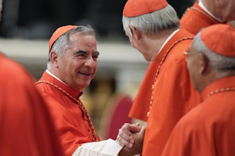 caption: Cardinal Angelo Becciu attends a consistory inside St. Peter's Basilica, at the Vatican, on Aug. 27, 2022.
