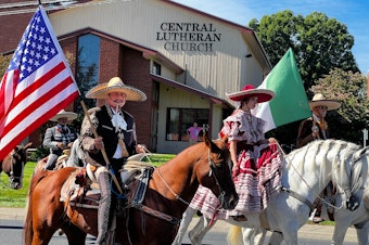 caption: Mexican-American “charros,” a group of skilled horse riders in costume, were a highlight of the 2022 Sunfair Parade in Yakima. 