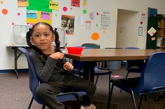 caption: Kindergartener Britta Ropati-Vao, 5, eats breakfast at CAYA before remote school starts.