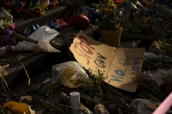 caption: ‘Stop gun violence now’ reads a sign during a unity walk in honor of 17-year-old Garfield high school student Amarr Murphy Paine, who was shot and killed at school, on Thursday, June 13, 2024, in Seattle. 