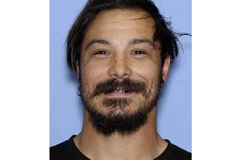 caption: This undated photo provided by the Wenatchee Police Department shows Travis Caleb Decker who the police are asking the public for help in locating the Washington state father who is wanted for murder after his three young daughters were reported missing and then found dead. 