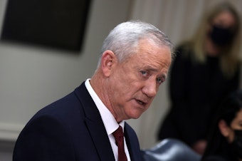 caption: Benny Gantz speaks at the Pentagon in December 2021 in Arlington, Va. Gantz, a former army chief and current minister in Israel's three-member war cabinet, said he would quit the government in three weeks if Prime Minister Benjamin Netanyahu does not advance a plan to replace Hamas in Gaza.