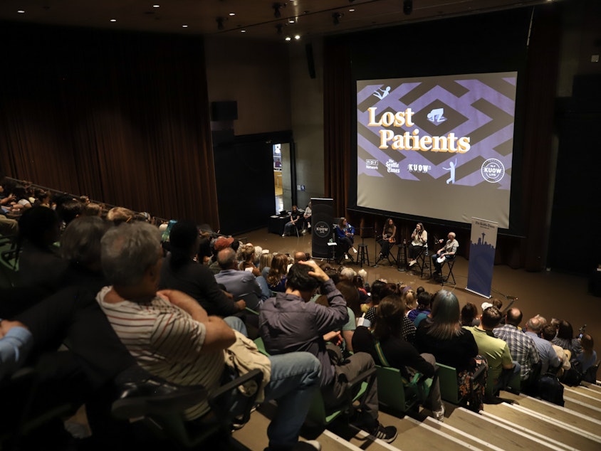 caption: A crowd turned out for the live conversation following the "Lost Patients" podcast series at the Seattle's Central Library on May 9, 2024.