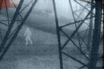 caption: An infrared image from 1:40 a.m. on Nov. 24, 2022, shows a person running beneath a transmission tower inside a Bonneville Power Administration substation in Oregon City, Oregon. 