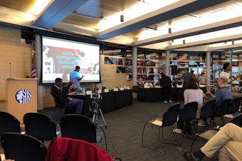 caption: Moderators of a youth-sponsored forum prepare to quiz candidates for local offices on Thursday at Seattle City Hall.