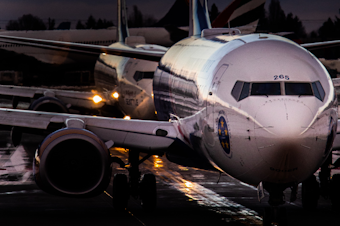 caption: Planes lineup for runway clearance at Sea-Tac International Airport.