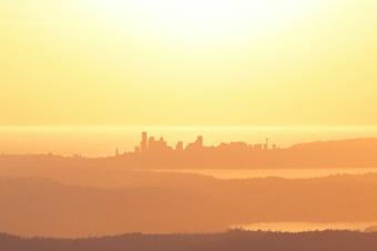 caption: A sunny day radiating above Seattle and Puget Sound. 