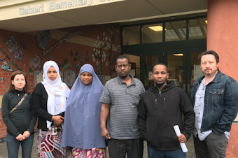 caption: Bailey Gatzert Elementary parents Amalia Icreverzi, Nimco Ahmed, Aisha Mohamed, Abu Mohamed, Ali Abdulaziz and Jaime Griesemer stood outside the school on June 24, 2019.